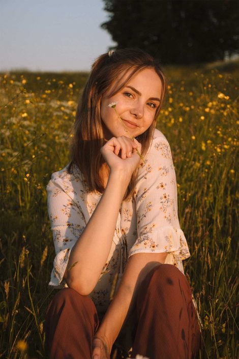woman outdoors crouching and looking cute having photo taken by fraser valley portrait photographer